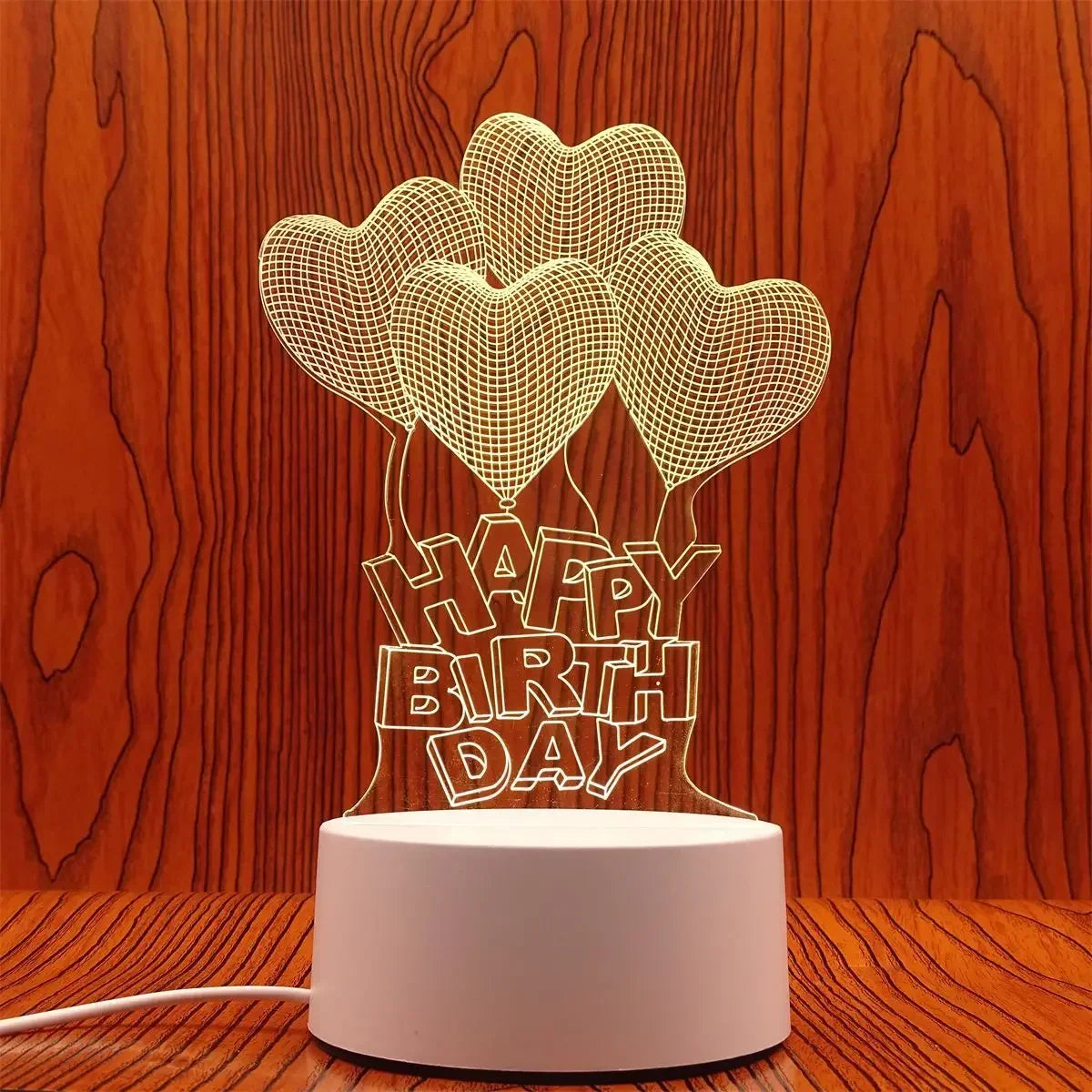 A decorative light display featuring three heart-shaped illusions made of wire mesh on a white base.
