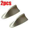 Two silver-colored shark fin car antennas for FM/AM signal enhancement.