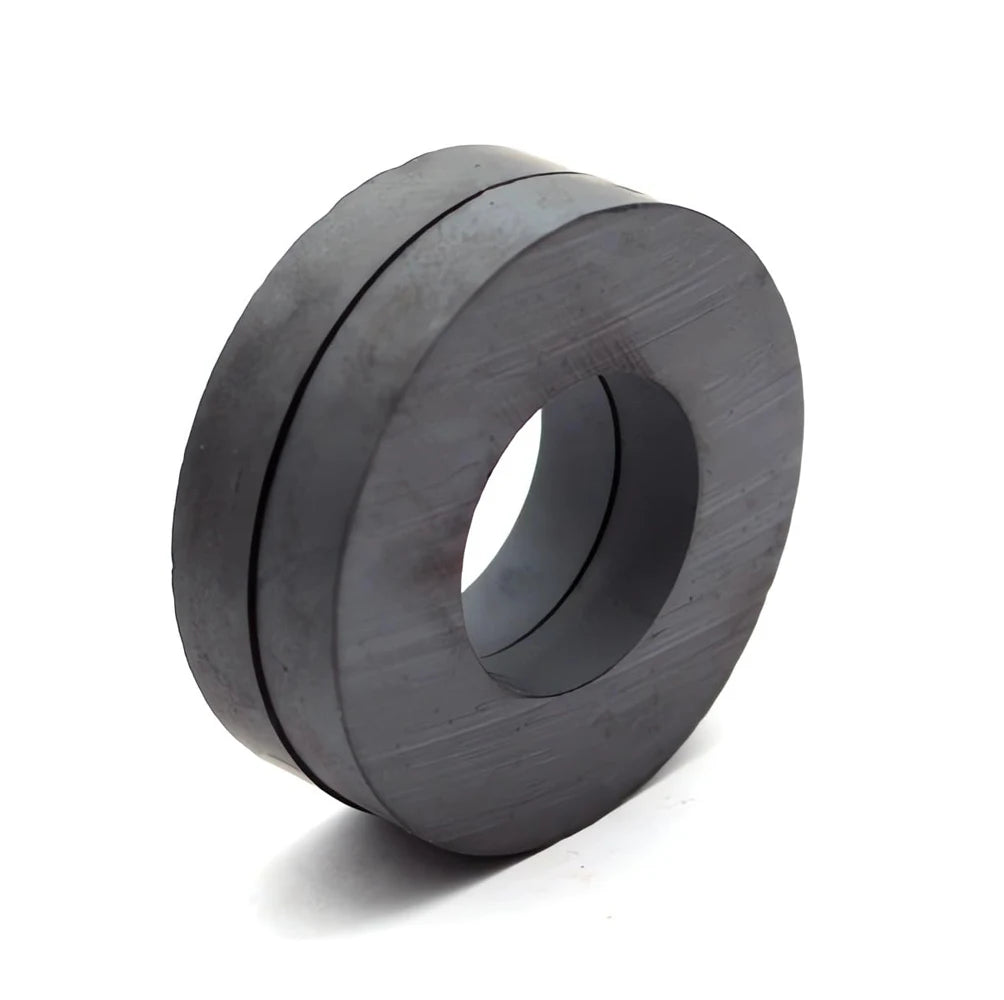 A close-up view of a dark gray industrial ceramic ring magnet with a smooth, cylindrical shape.