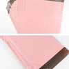 A stack of pink waterproof poly mailer shipping bags with brown sealing strips.