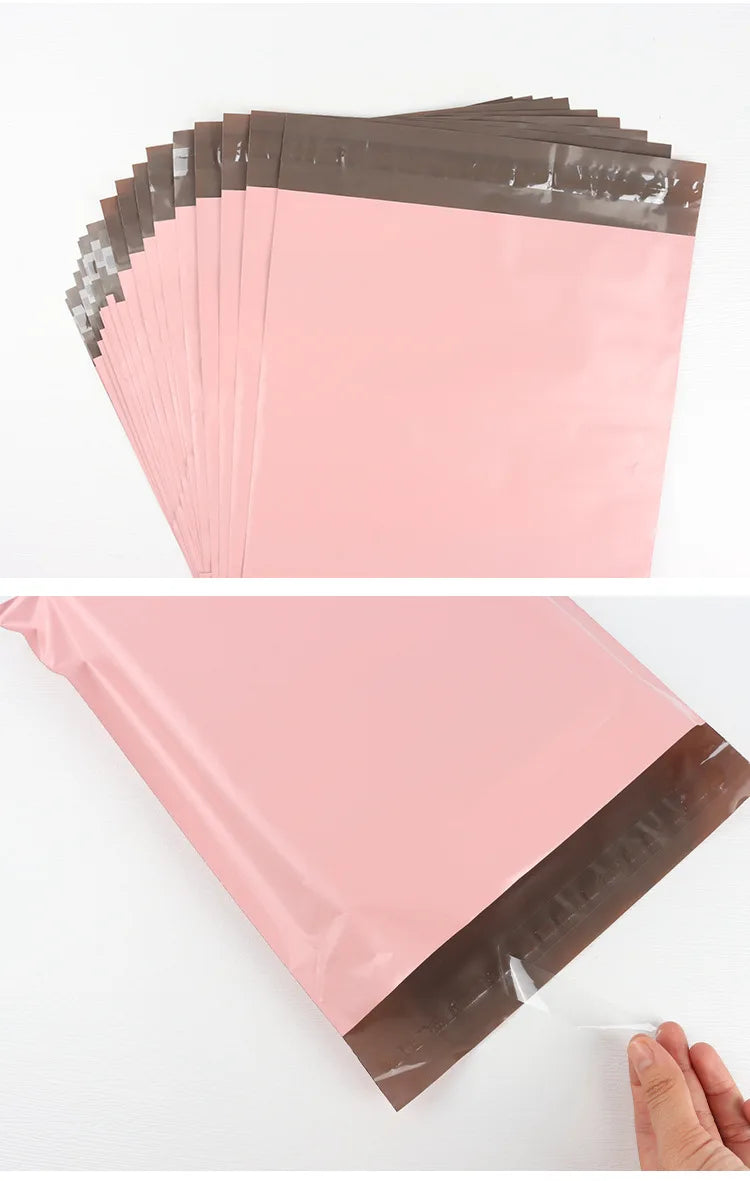 A stack of pink waterproof poly mailer shipping bags with brown sealing strips.
