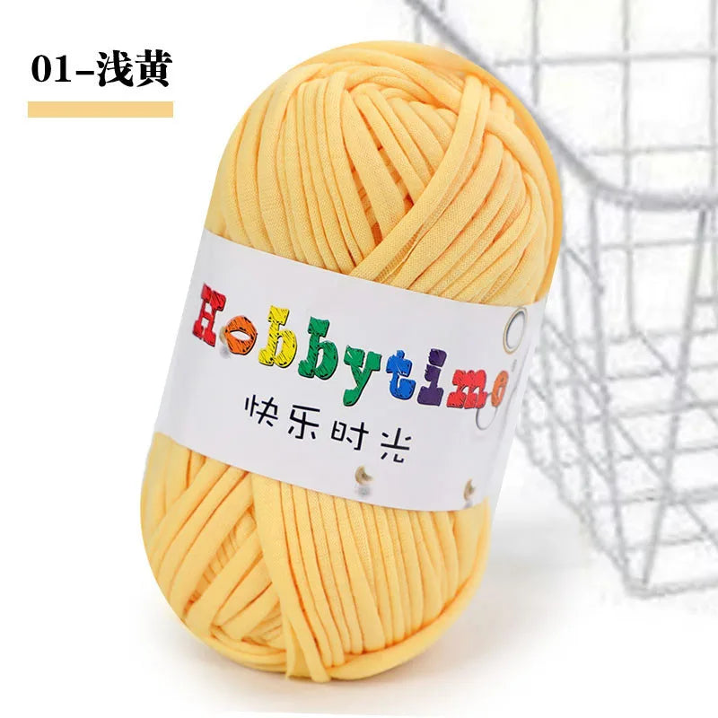A ball of yellow soft T-shirt yarn for crochet and knitting is shown next to a wire basket.