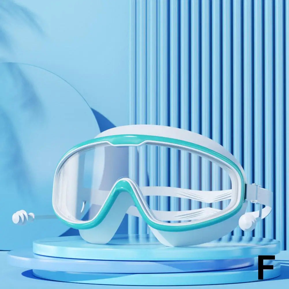 White anti-fog swim goggles with integrated earplugs displayed on a blue circular stand.