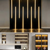 Modern interior featuring vertical black slat wall illuminated by vertical warm LED strip lights.