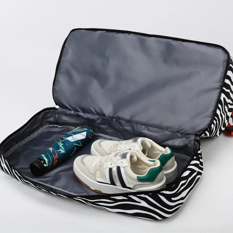A black and white zebra print duffle bag is open, revealing a pair of light-colored sneakers inside.