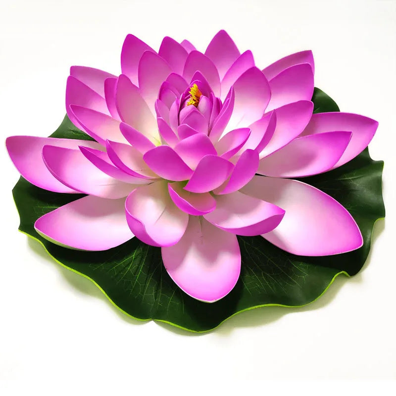 A vibrant pink lotus flower with layered petals rests on a green leaf.