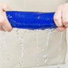 A hand is squeezing a bright blue thickened microfiber cleaning towel, with water dripping from the towel.