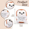 Handcrafted crocheted plush ornaments showing different sizes of cute, smiling, white animal figures.