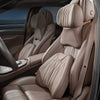 Interior view of a car seat showing memory foam lumbar support and neck pillow set in beige leather upholstery