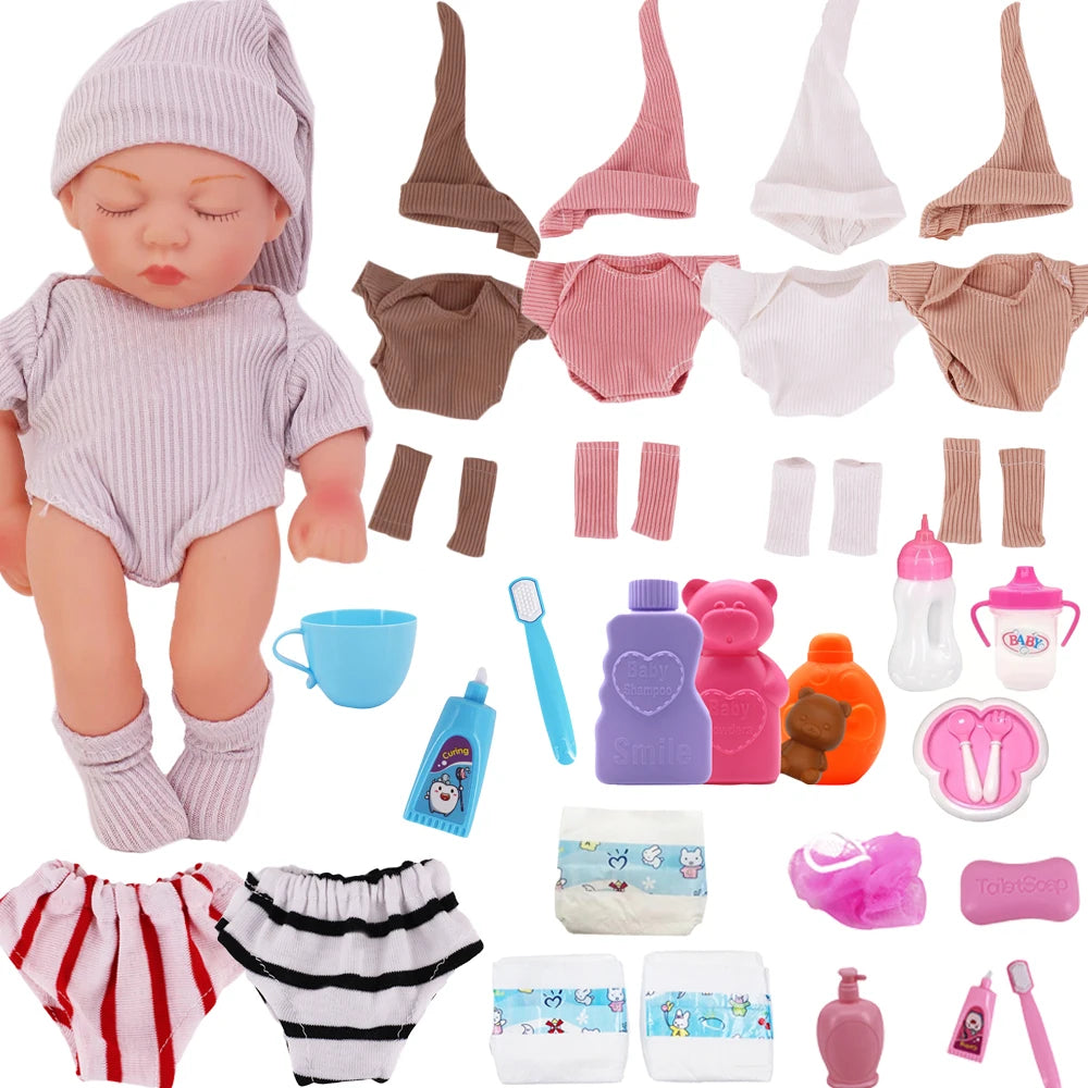 A set of clothing and hat for a baby doll including a jumpsuit, socks, and various accessories.