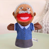 A soft plush hand puppet with gray hair and a red mouth, wearing a blue shirt and gray overalls.
