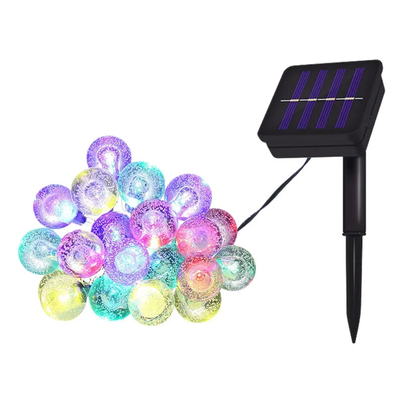 String lights featuring colorful crystal globe bulbs powered by a solar panel.