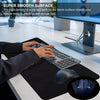 A hand is using a computer mouse on a black desk mat, demonstrating the smooth surface of a gaming accessory.