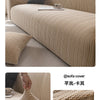 A beige quilted stretch sofa cover featuring a textured knit pattern on a sofa, shown in detail.