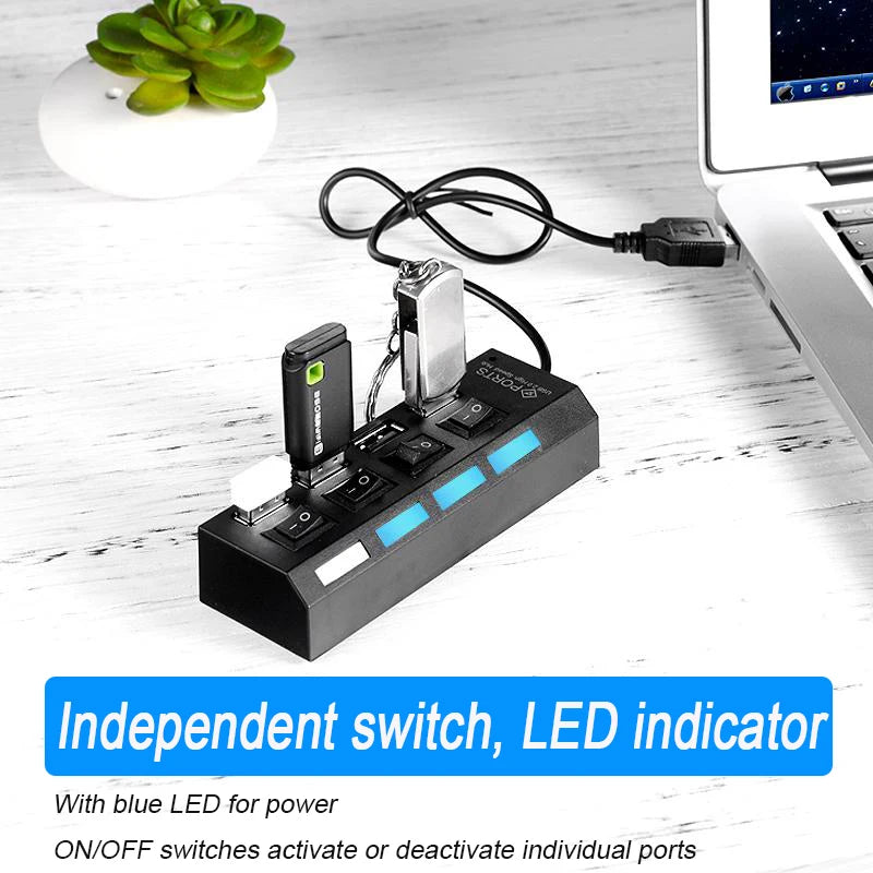 A black USB 2.0 multi-port hub with an independent switch and LED indicator connected to a laptop.
