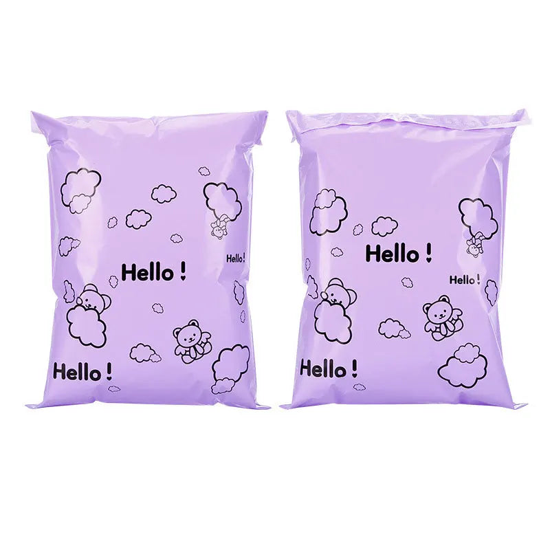 Two purple self-sealing mailing bags featuring a white cloud and bear design.