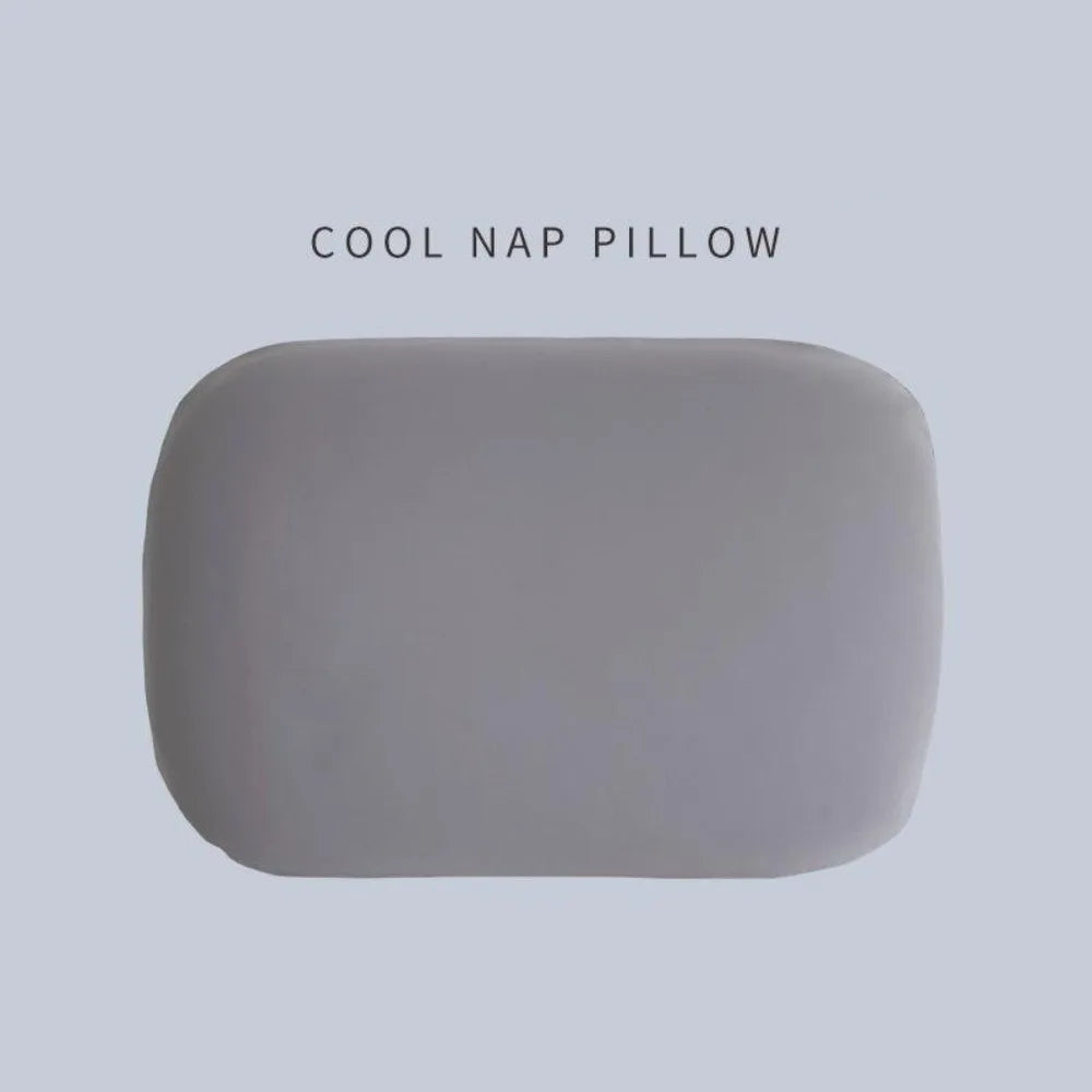 A smooth, oval-shaped gray memory foam travel neck pillow with a soft polyester cover.