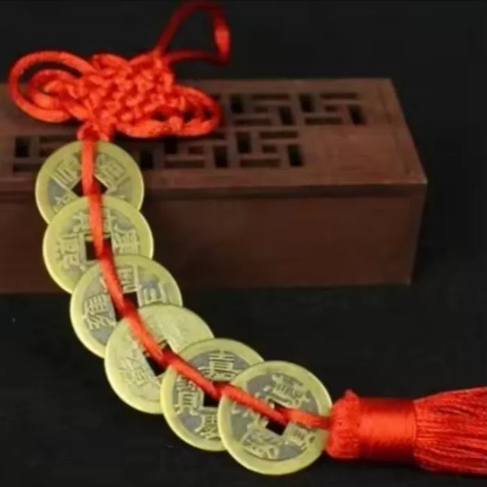 Chinese Feng Shui wealth coins strung together with a red handmade knot