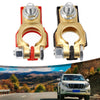 A pair of quick-release copper car battery terminals are shown against a scenic mountain landscape.