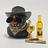 A black rubber duck car ornament with a gold chain and a yellow bottle is displayed on a white surface.