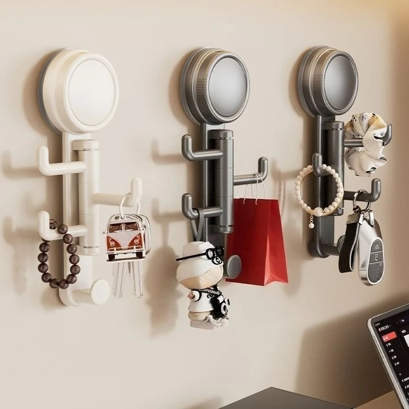 A set of modern, silver suction cup hooks mounted on a wall, featuring various hanging items like jewelry and accessories.