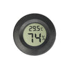 A round, black digital thermometer displaying 29.5°C and 74% humidity.