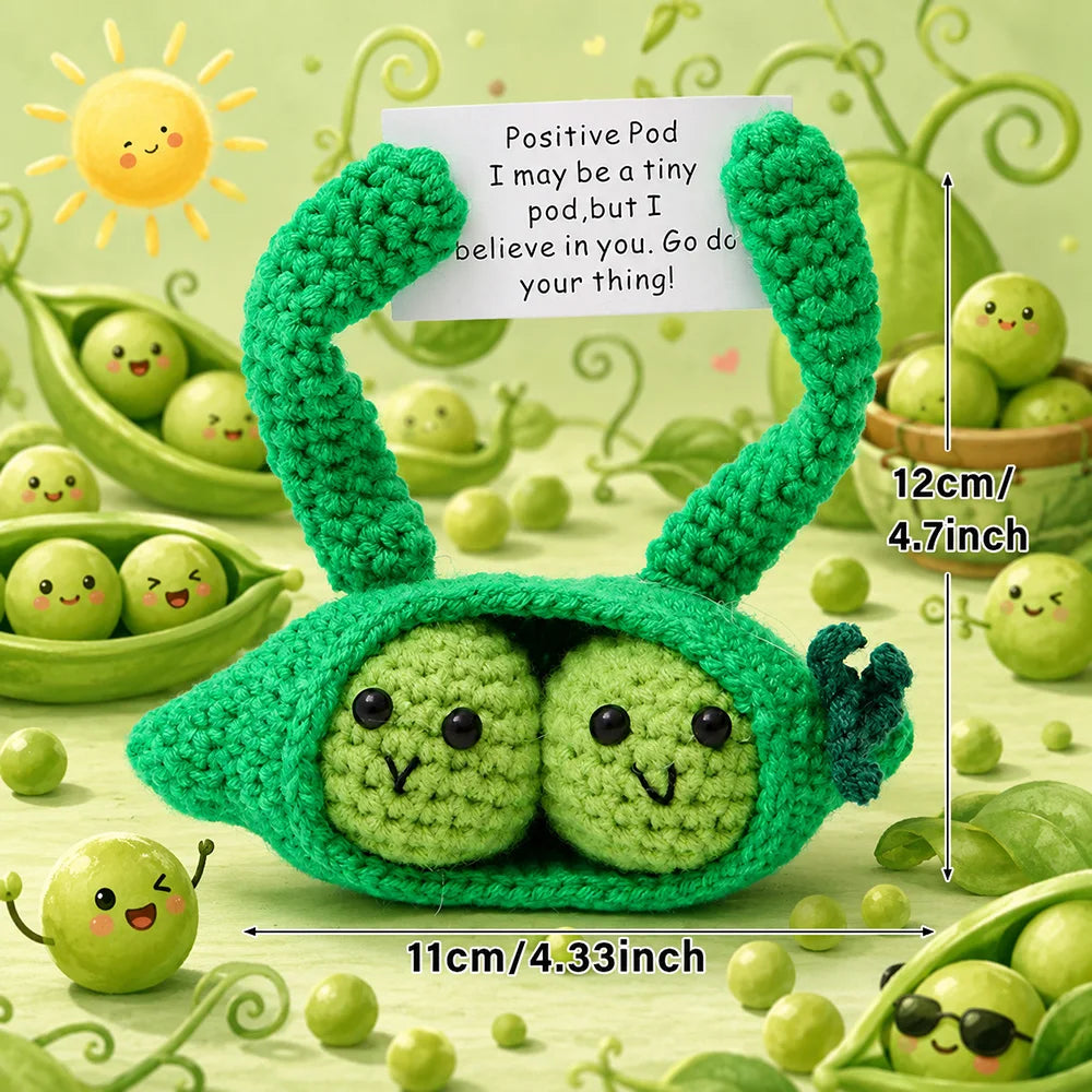 Handmade crochet pocket hug doll shaped like a green caterpillar with a positive message tag.