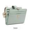 A light mint green bi-fold credit card wallet with a gold chain and leather accents.