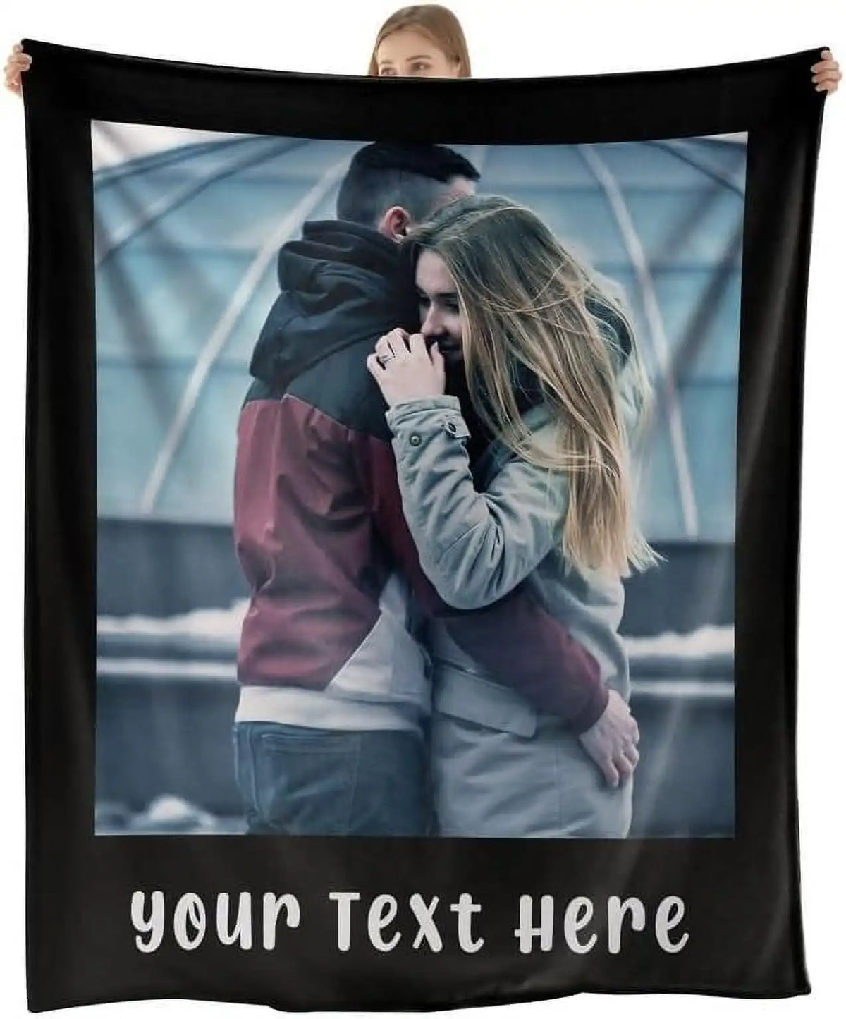 A black photo blanket featuring a couple embracing in an outdoor setting with a light blue background.