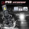 A close-up of an IP68 waterproof LED headlight bulb being tested in a water spray against a car's front grille.