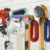 A collection of heavy-duty garage storage hooks for various garden tools, including shovels and other implements.