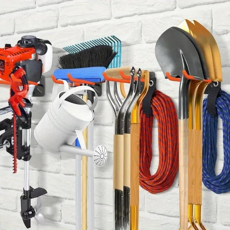 A collection of heavy-duty garage storage hooks for various garden tools, including shovels and other implements.