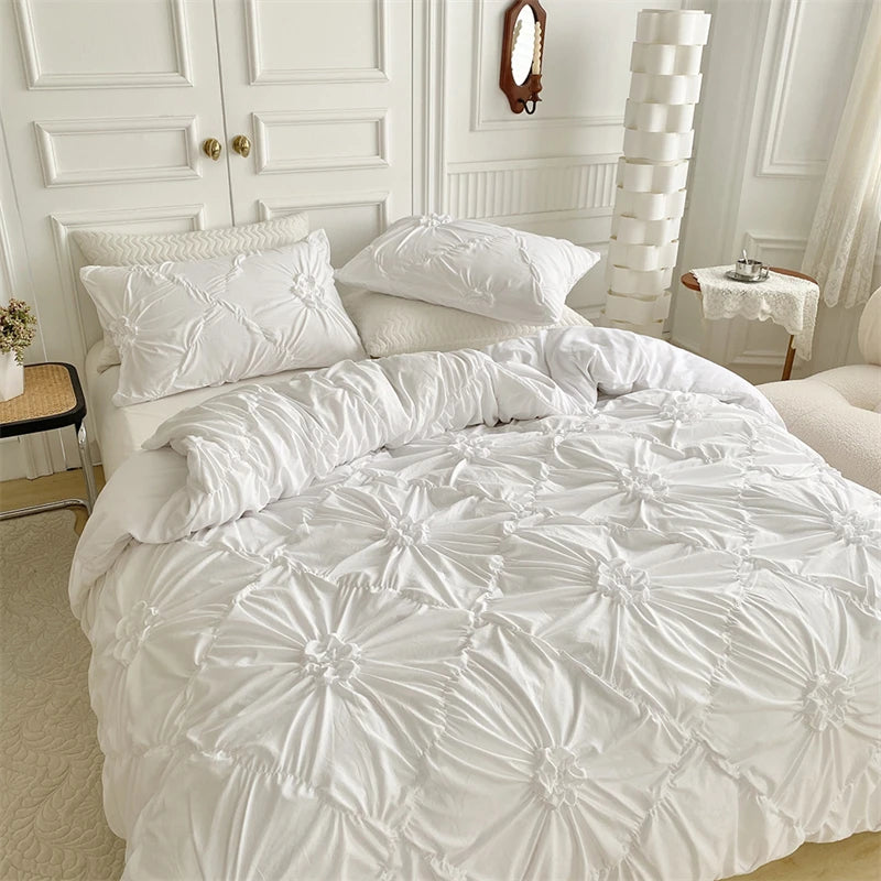 White luxury duvet cover set featuring a 3D twist floral pinch-pleated pattern on a bed.