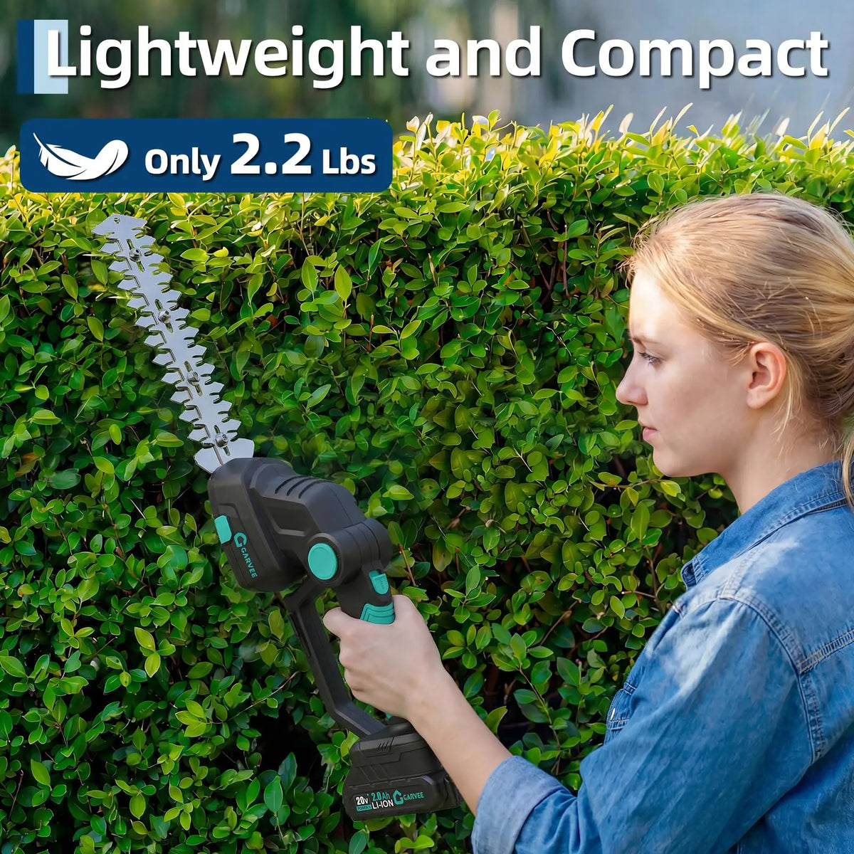 A woman is using a lightweight and compact cordless grass shear and hedge trimmer against a green hedge.