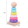 A stack of wooden alphabet number and shape puzzle boards in various pastel colors, showing the height and base.