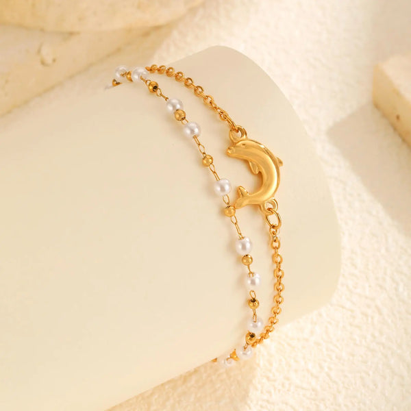 Gold stainless steel double-layer bead anklet with a crescent moon charm displayed on a light background.