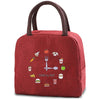 A maroon insulated lunch bag featuring various food icons like a fork, sandwich, and apple.