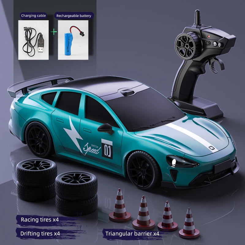 A teal RC drift truck is shown with accessories like charging cables, tires, and a triangular barrier.
