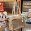 A beige Y2K Lolita transparent shoulder bag with lace trim hanging in a display case.