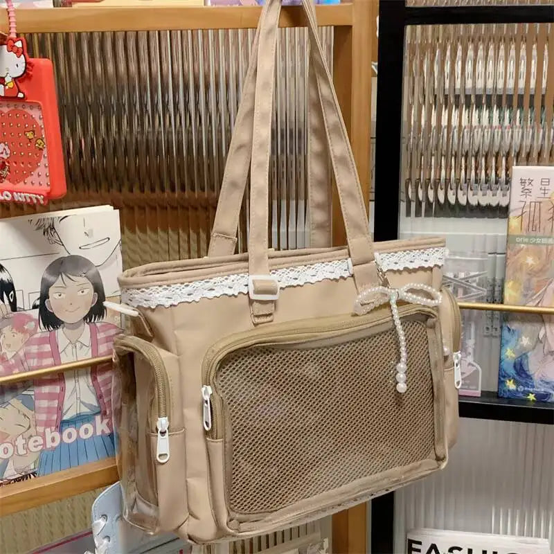 A beige Y2K Lolita transparent shoulder bag with lace trim hanging in a display case.