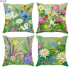 A set of four floral throw pillow covers featuring colorful wildflowers, butterflies, and insects on a green background.