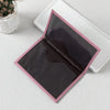 A pink-edged black PU leather passport holder with card slots is shown open on a white surface.