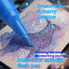 A blue soft-tip flash pen is drawing a purple glitter design on paper for a crafting journal.