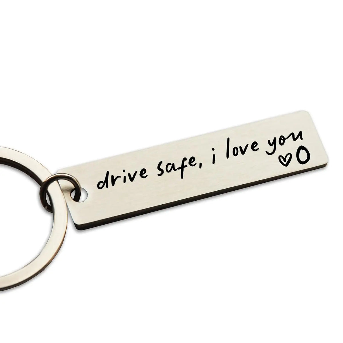 A personalized stainless steel keychain tag engraved with the message drive safe i love you and a heart symbol.