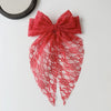 A vibrant red lace bow accessory for hair, featuring intricate floral patterns and a sheer fabric.