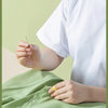 A person is using a needle to sew fabric, demonstrating the complete 42-piece hand sewing kit.