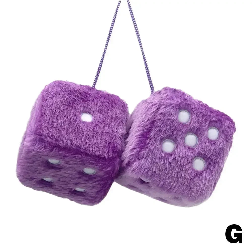A pair of purple plush velvet dice hanging by a string.