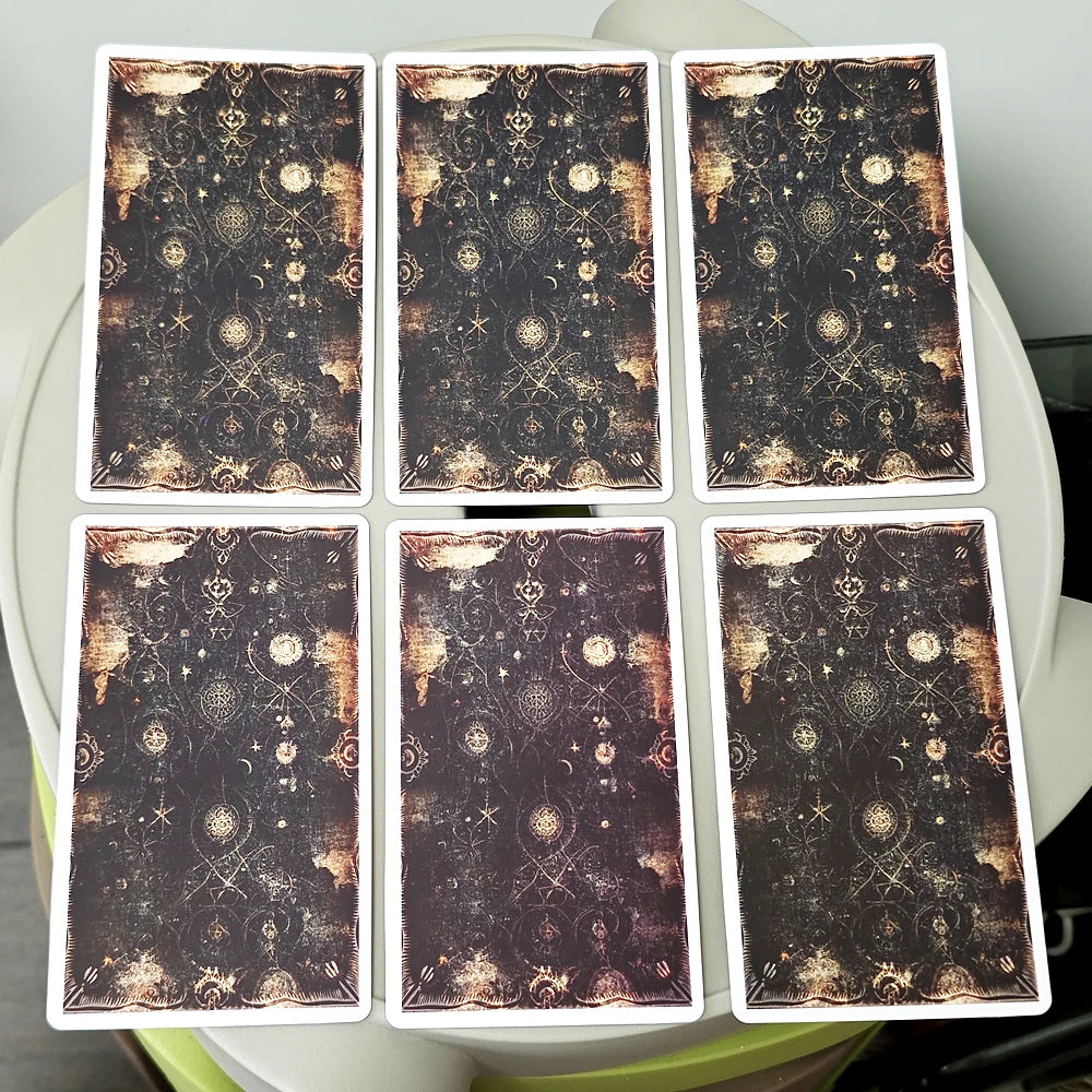 A set of twenty oracle cards featuring dark, ornate designs and gold accents.