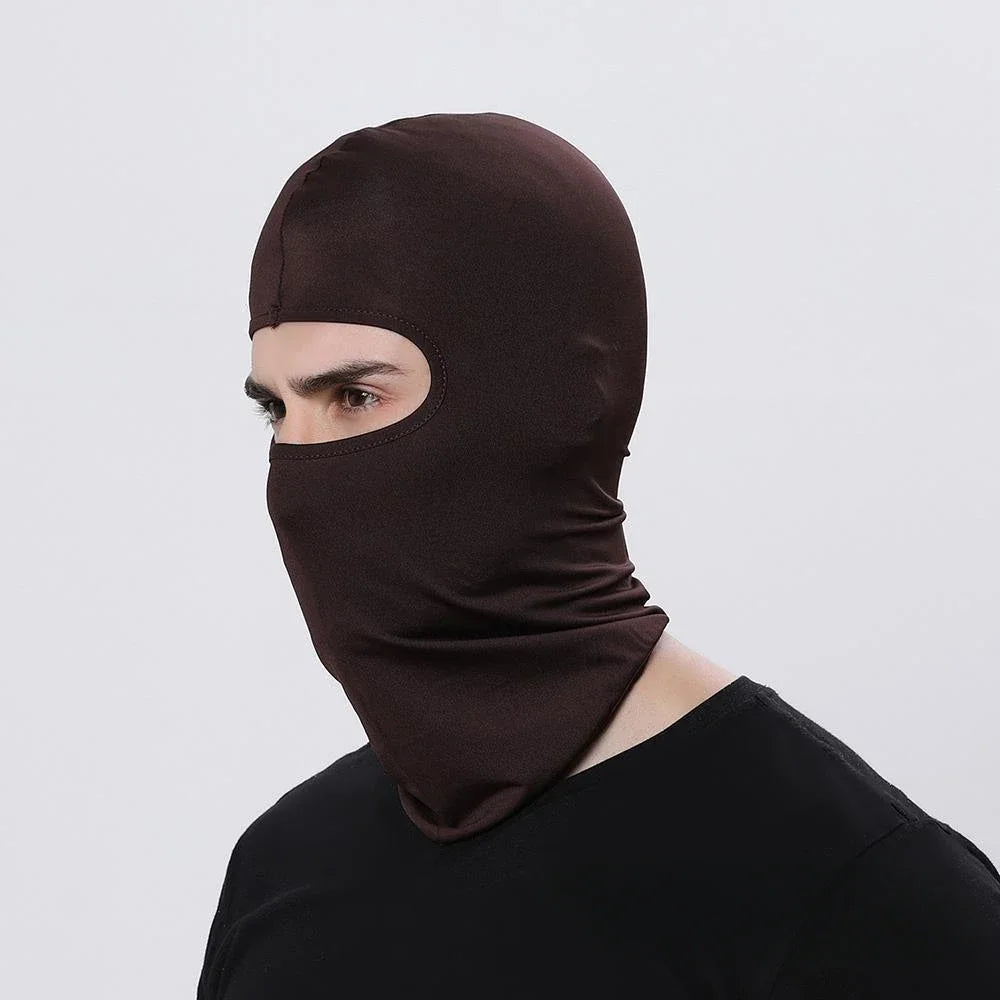 A person wearing a dark brown windproof full face balaclava against a light background.