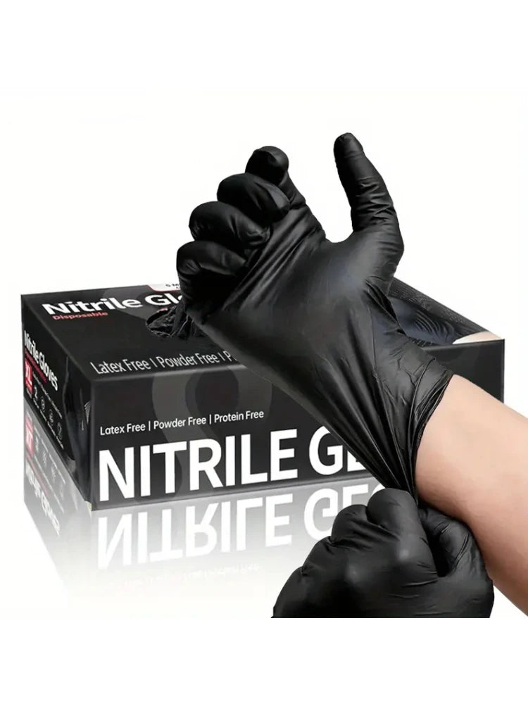 A hand wearing a black disposable nitrile cleaning glove is shown holding up the glove.